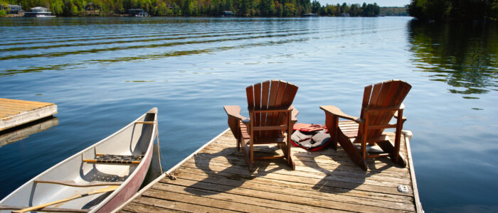 Ontario Canada Lake with canoes and chairs
